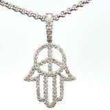 peace symbol pendant with diamonds white gold close up