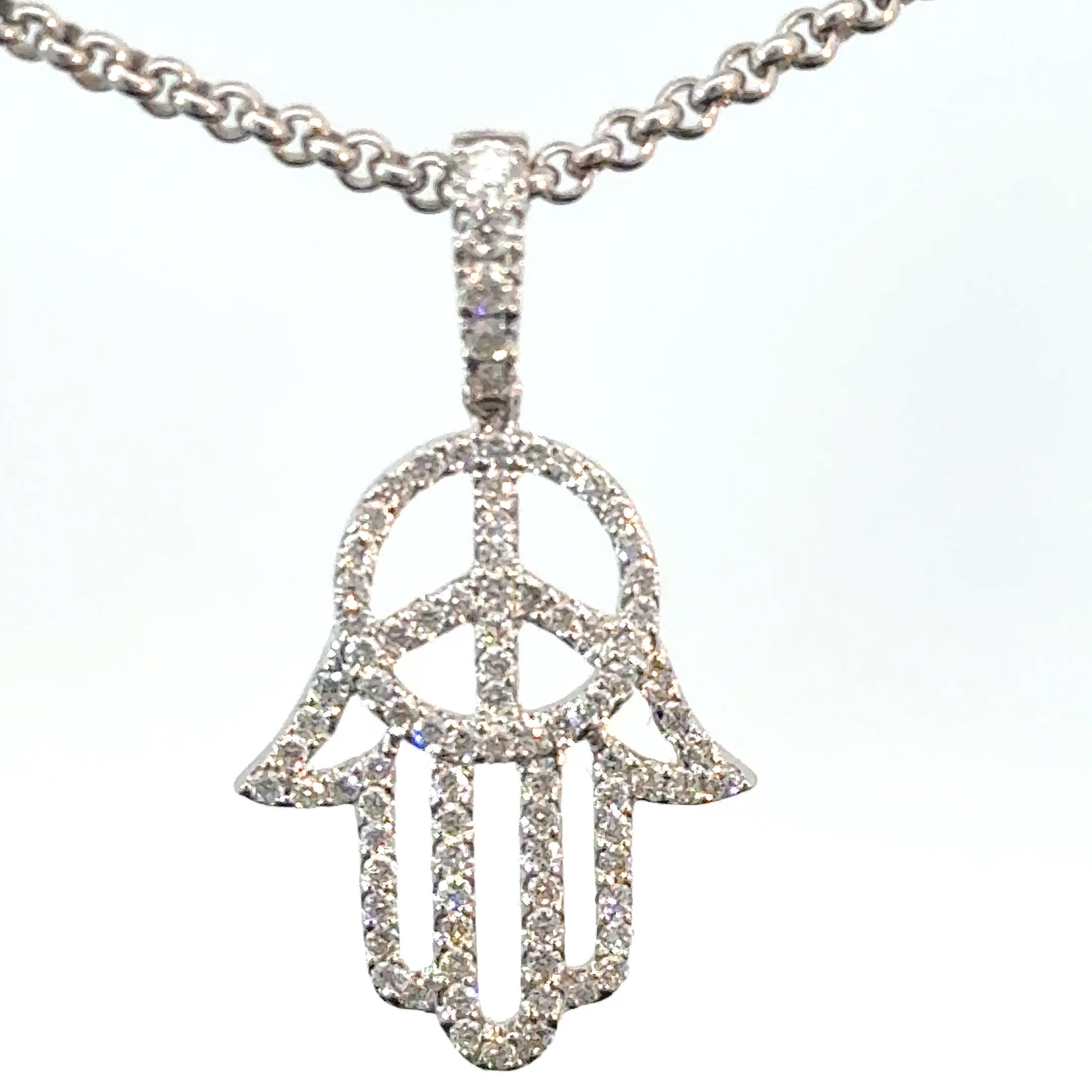 peace symbol pendant with diamonds white gold close up