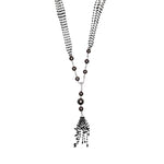 Busatti 18k gold collier necklace with black diamonds and dark pearls featuring tassel pendant design worn on model