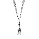Busatti 18k gold collier necklace with black diamonds and dark pearls featuring tassel pendant design worn on model