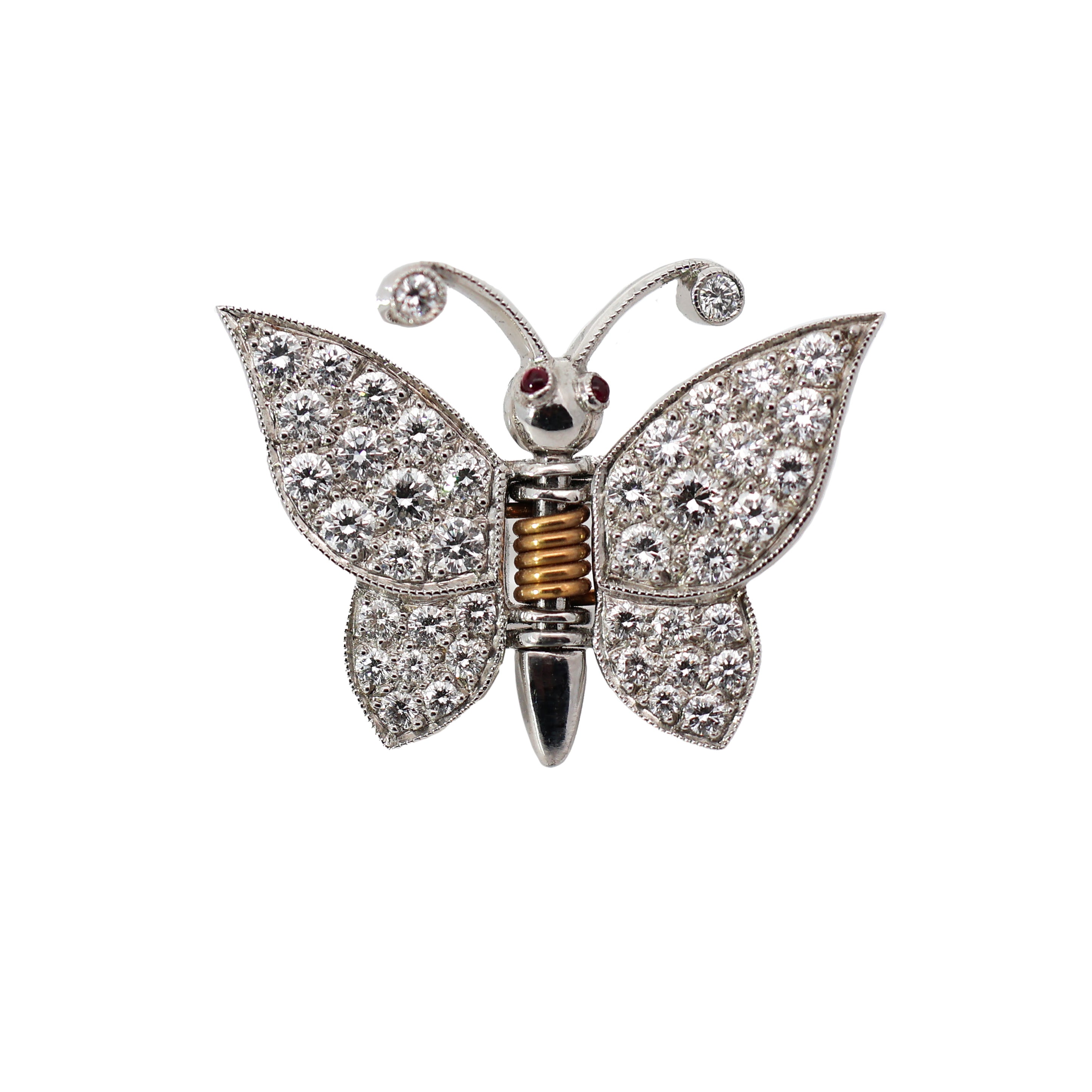 18K gold butterfly brooch with diamond wings and ruby eyes on white background, featuring spring mechanism for multi-use styling
