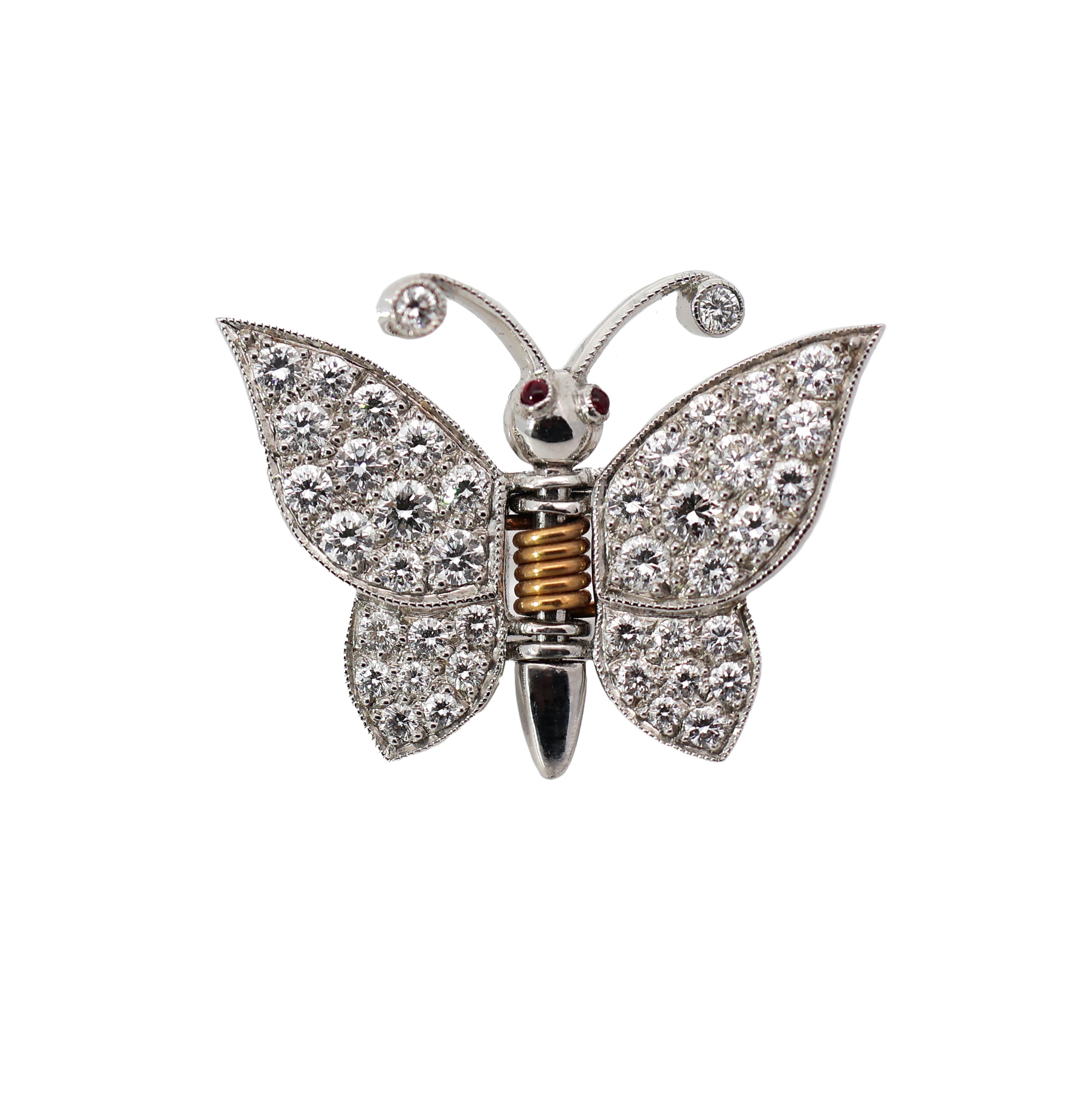 18K gold butterfly brooch with diamond wings and ruby eyes on white background, featuring spring mechanism for multi-use styling