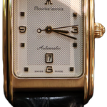 Maurice Lacroix 18K gold rectangular wristwatch with white dial and black leather strap, elegant Swiss luxury dress watch isolated on white background