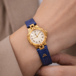Maurice Lacroix Damen Uhr Gold mit blauem Lederarmband am Handgelenk
